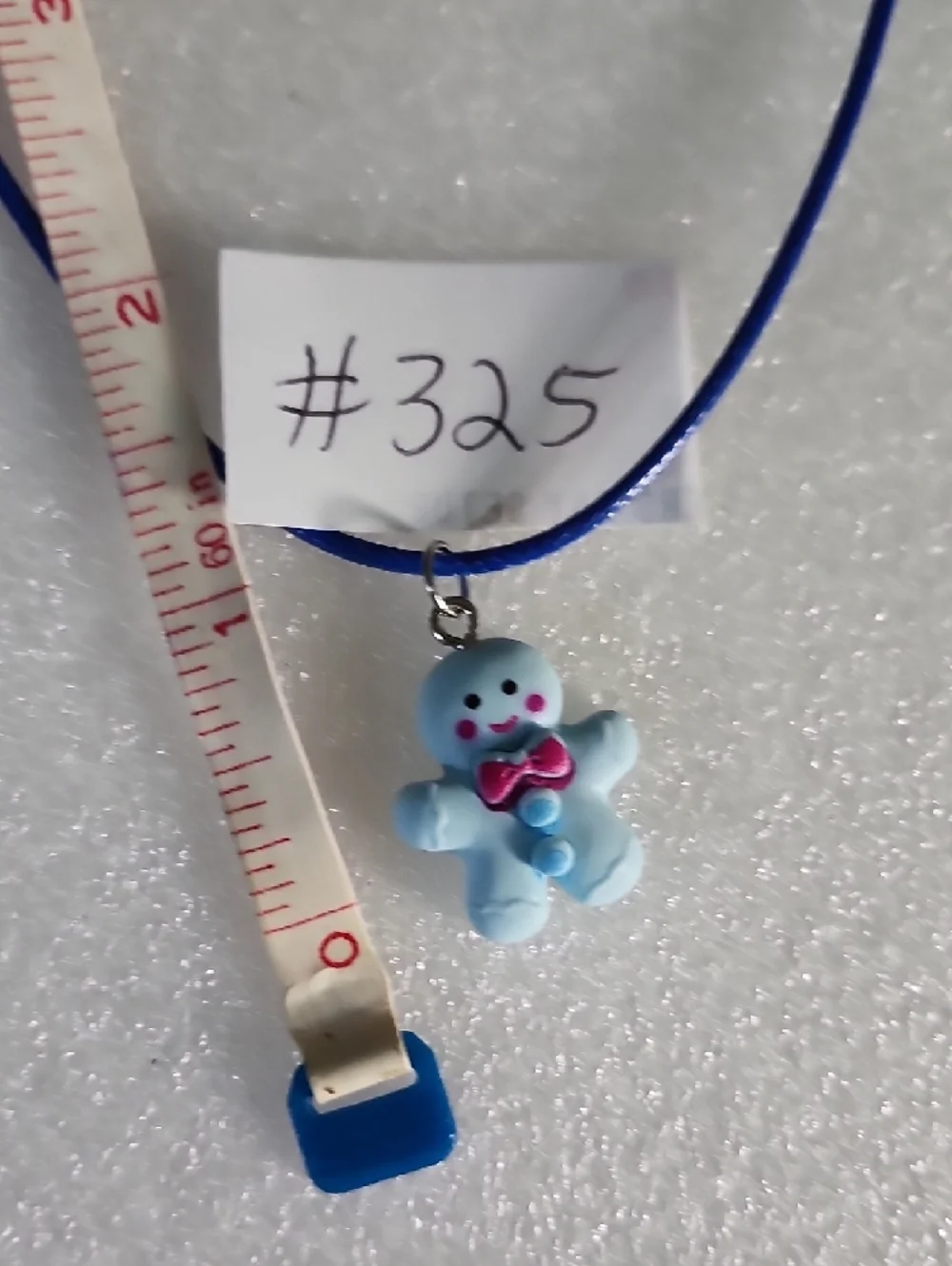 Hand Crafted Blue Gingerbread Man Necklace with Pink Bow